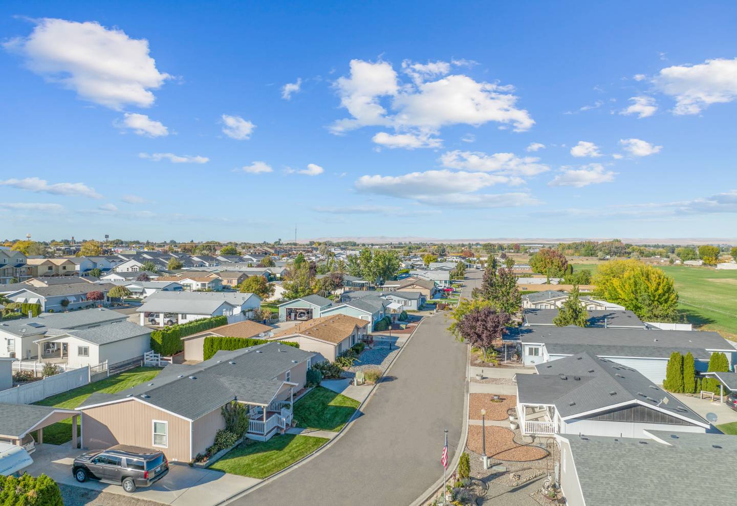 Photo of a manufactured home community with rolling hills in the background