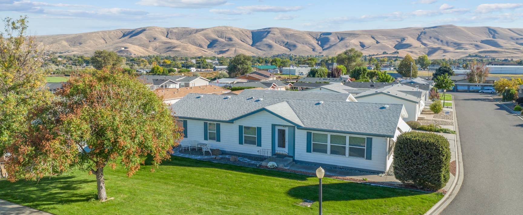 Photo looking down on house and community in the background