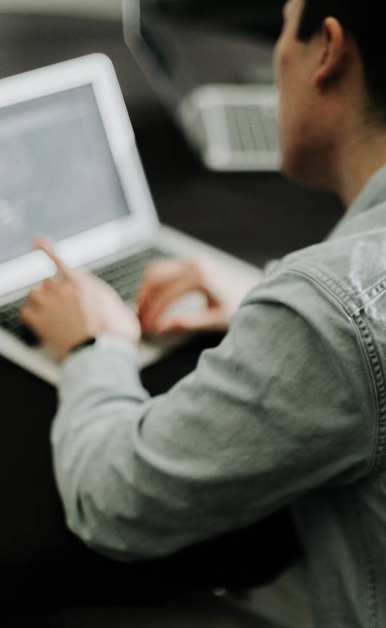 Photo of a person working on a laptop