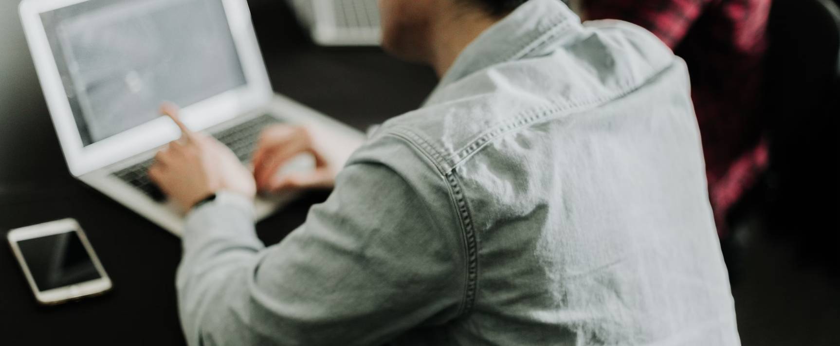 Photo of a person working on a laptop