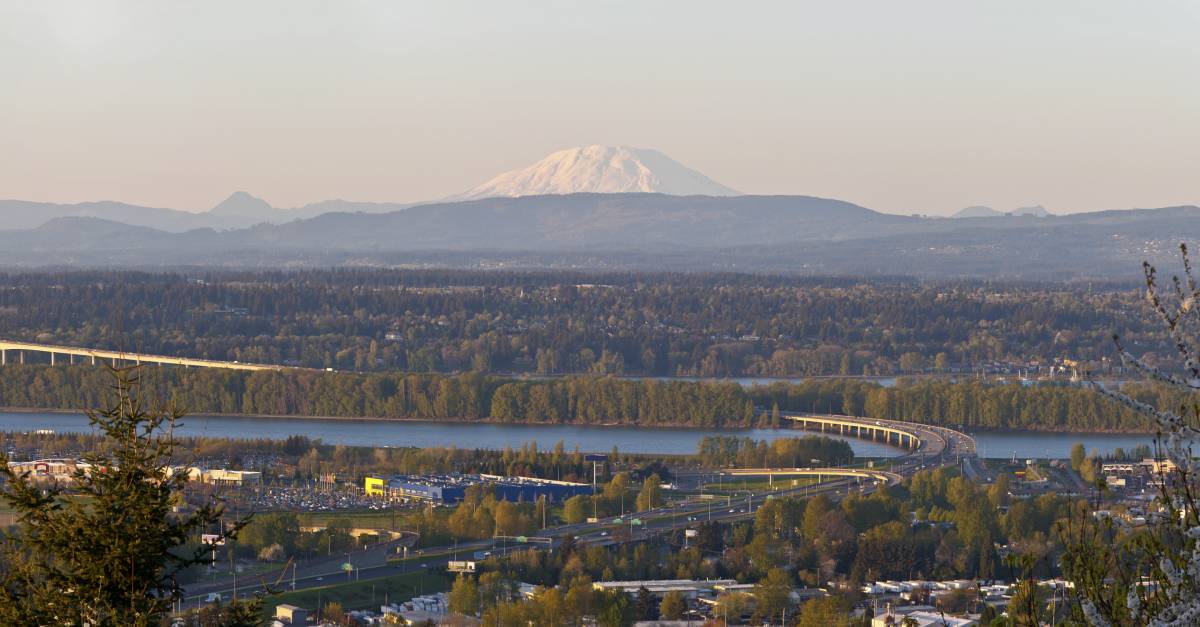 Photo of a river with a mountain on the horizon